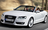Audi A5 Cabrio. Modelo 2009. Imagen exterior. Frontal lateral. Movimiento. Carretera. Blanco.