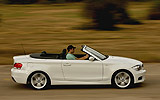 BMW Serie 1 Cabrio. Modelo 2009. Imagen. Cenital lateral. Movimiento. Carretera. Alpinweiss. Llanta 18 pulgadas 5 radios Estrella.