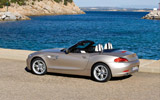 BMW Z4. Modelo 2009. Imagen exterior. Lateral posterior. Coche parado. Descapotado. Carretera.
