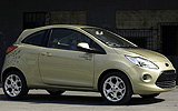 Ford Ka. Modelo 2009. Imagen exterior. Lateral frontal. Coche parado. Carretera. Dorado.