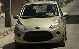 Ford Ka. Modelo 2009. Imagen exterior. Frontal. Coche parado. Carretera. Dorado.