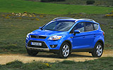 Ford Kuga. Modelo 2009. Imagen. Exterior. Frontal lateral. Coche parado. Carretera. Azul.