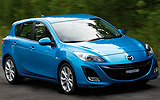 Mazda3. Modelo 2009. Imagen. Exterior. Lateral frontal. Coche en movimiento. Carretera. Color Celestial Blue Mica.
