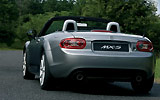 Mazda MX-5. Soft Top. Modelo 2009. Imagen exterior. Lateral- posterior. Coche parado. Descapotado. Carretera. Gris.