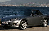 Mazda MX-5. Soft Top. Modelo 2009. Imagen exterior. Frontal lateral. Coche parado. Carretera. Gris.