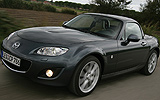 Mazda MX-5. Roadster Coup&eacute;. Modelo 2009. Imagen exterior. Frontal lateral. Movimiento. Carretera. Gris.