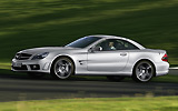 Mercedes-Benz SL 65 AMG. Modelo 2008. Imagen. Frontal- lateral. Coche en movimiento. Carretera. Plata iridio.