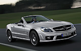 Mercedes-Benz SL 65 AMG. Modelo 2008. Imagen. Lateral- frontal. Coche en movimiento. Descapotado. Carretera. Plata iridio.