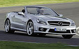 Mercedes-Benz SL 65 AMG. Modelo 2008. Imagen. Lateral- frontal. Coche en movimiento. Descapotado. Carretera en curva. Plata iridio.