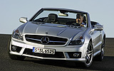 Mercedes-Benz SL 65 AMG. Modelo 2008. Imagen. Frontal- lateral. Coche parado. Descapotado. Carretera. Llantas aleaci�n AMG 19 pulgadas y radios dobles. Plata iridio.