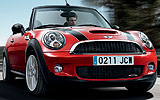 MINI John Cooper Works Cabrio. Modelo 2009. Imagen. Exterior. Lateral frontal. Movimiento en carretera. Rojo.