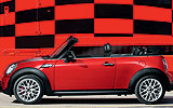 MINI John Cooper Works Cabrio. Modelo 2009. Imagen. Exterior. Lateral. Coche parado. Carretera. Rojo.