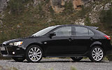 Mitsubishi Lancer Sportback. Modelo 2009. Imagen exterior. Lateral. Coche parado. Carretera. Negro