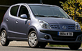 Nissan Pixo. Modelo 2009. Imagen. Exterior. Frontal lateral. Coche parado. Carretera.