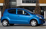 Nissan Pixo. Modelo 2009. Imagen. Exterior. Lateral. Coche parado. Carretera. Azul.