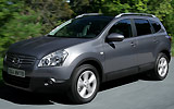 Nissan Qashqai+2. Modelo 2009. Imagen. Frontal- lateral. Movimiento. Carretera. Gris.