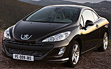 Peugeot 308 CC. Modelo 2009. Imagen. Exterior. Frontal lateral. Coche parado. Carretera. Techo r�gido plegable. Marr�n tierra.