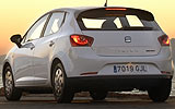 SEAT Ibiza ECOMOTIVE. Modelo 2009. Imagen. Exterior. Lateral posterior. Coche parado. Carretera. Pilotos en on. Blanco.