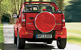 Suzuki Jimny. Modelo 2008. Imagen exterior. Posterior. Descapotado. Coche parado. Carretera. Rojo.