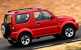 Suzuki Jimny. Modelo 2008. Imagen exterior. Lateral. Movimiento. Carretera. Rojo.