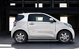 Toyota iQ. Modelo 2009. Imagen. Lateral. Coche parado. Carretera. Blanco.